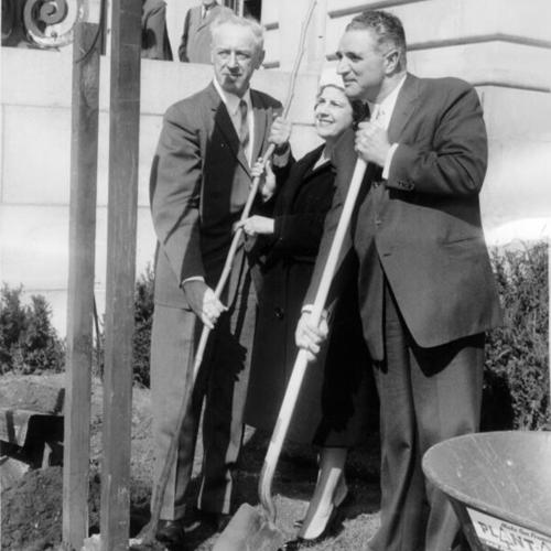 [Sherman P. Duckel and Mr. and Mrs George Christopher planting a tree on the front lawn of City Hall]