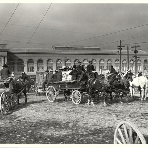 [Group of people on a horse drawn carriage near the Ferry Building, after the earthquake of April 18, 1906]