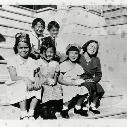 [Children sitting and smiling on steps of a house during a birthday party for Michko in 1934]