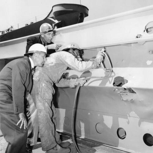[Fred Zweifel, William J. Bell and Aneas Leary working on the U.S.S. San Francisco memorial prior to its installation at Land's End in San Francisco]