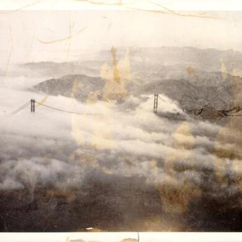 [Aerial view of fog over Golden Gate Bridge photographed from American Airlines Flagship Skysleeper]