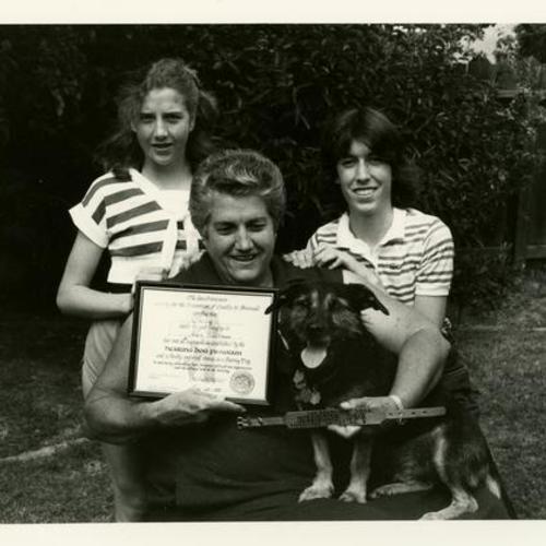 Allene Nattrass with two others holding certificate for hearing dog Smiley
