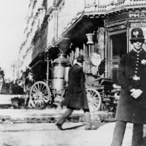 [Policeman standing in front of Baldwin Hotel after fire]