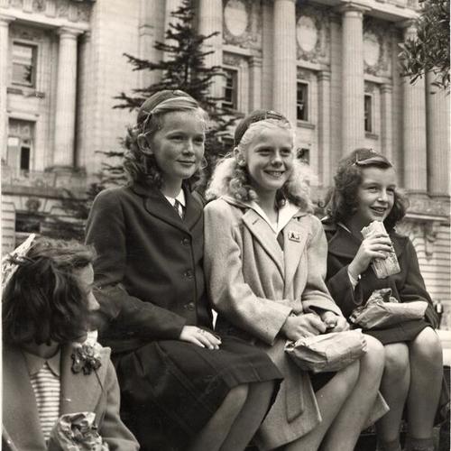 [San Francisco Camp Fire Girls Rosalie Judith Spread, Barbara McClure and Gloria Farber eating lunch at the Civic Center after a trip through the City Hall]