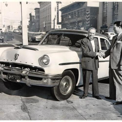 [August H. Wilhelm purchasing a Mercury sedan from E. M. Boyson, general manager of Van Etta Motors]