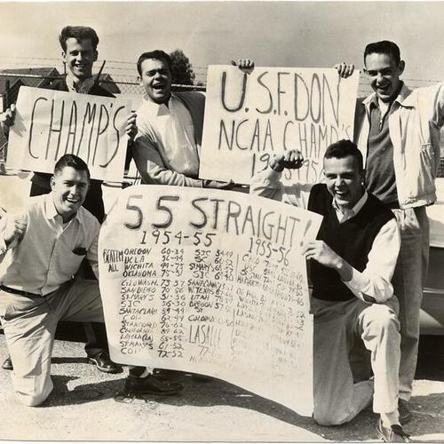 [University of San Francisco students holding signs honoring the school's basketball team]