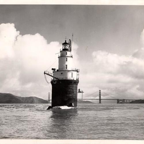 [Mile Rock lighthouse and the Golden Gate Bridge in the background]