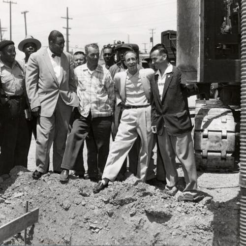 [Harry Bridges and other longshoremen leaders watching first pile being driven during construction of Bay Area Longshoremen's Memorial Hall at Mason and Beach streets]