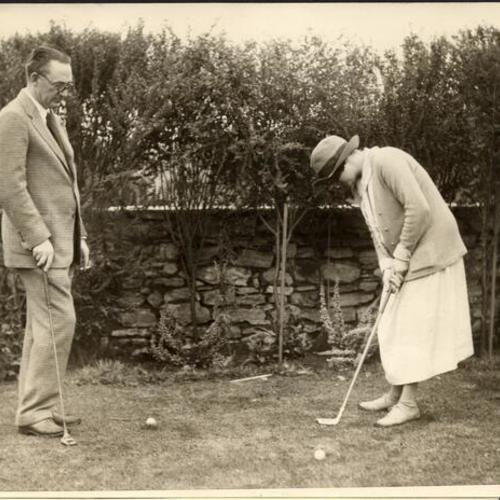 [Mr. and Mrs. Gouverneur Morris practicing golf]