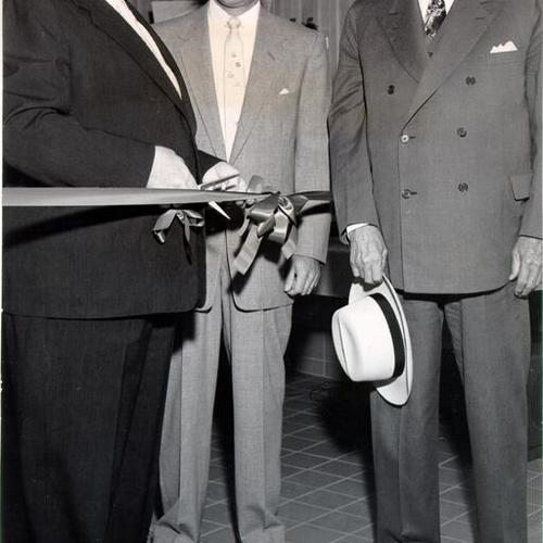 [Mayor Elmer Robinson cutting the ribbon at opening ceremonies for a new Sommer & Kaufmann shoe store on Union Square]