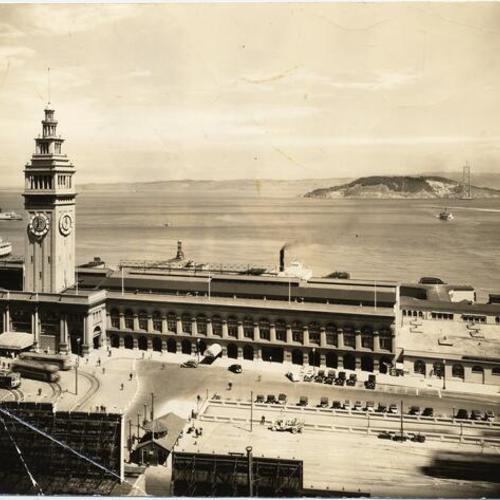 [View of Ferry Building with Bay Bridge under construction in background]