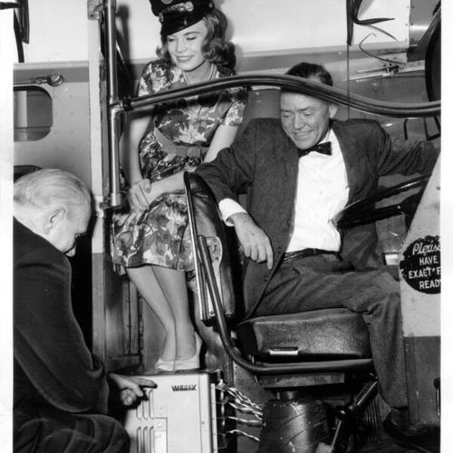[William McRobbie, Sally Ann Hamberlin and Bill Rushing posing for a picture on a Muni bus]