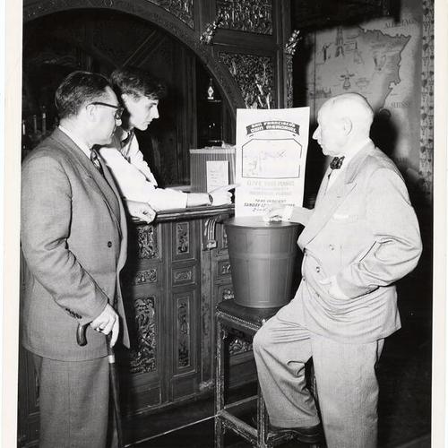 [Harry Lawlor, Frank Fahey and Paul Verdier with a bucket to be used in a campaign to raise money for a plaque for the U.S.S. San Francisco memorial at Land's End in San Francisco]