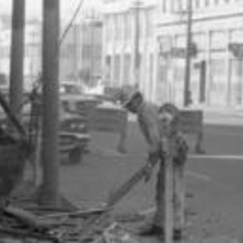 [Worker clears debris during demolition of buildings on 700 block of Howard, part of South of Market Redevelopment]