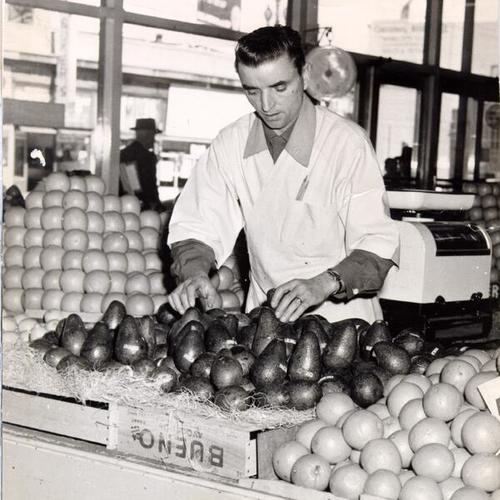 [Pete Giannini arranging avocados at the Crystal Palace Market]