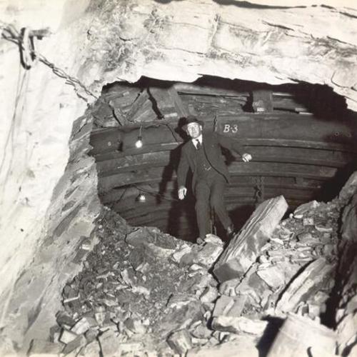 [Thomas Connelly, tunnel contractor, inspecting inside the tunnel on Yerba Buena Island during San Francisco-Oakland Bay Bridge construction]