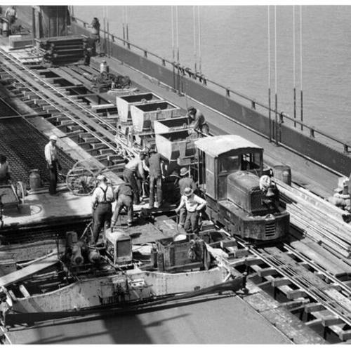 [Bridge workers on the deck of the San Francisco-Oakland Bay Bridge]
