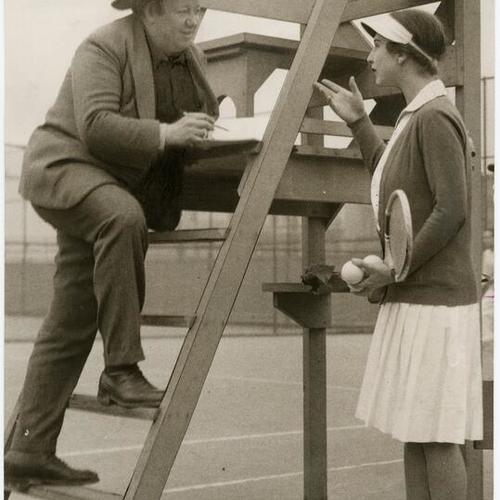 [Mexican artist Diego Rivera talking with Helen Wills on a tennis court]