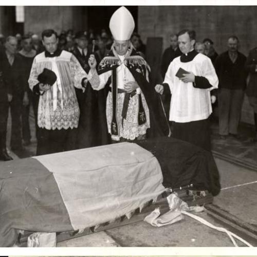 [Archbishop John J. Mitty blessing the remains of Father Damien, the leper priest]
