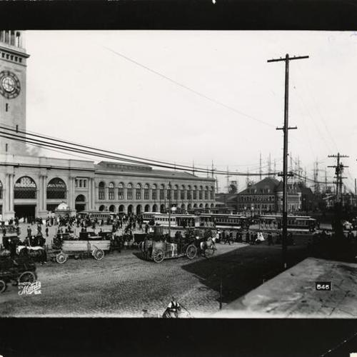 [Streetcars and horse drawn wagons in front of the Ferry Building]