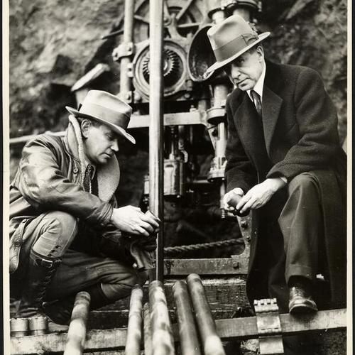[Joseph Strauss (right) and unidentified person during construction of Golden Gate Bridge]
