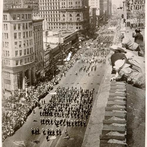 [Photograph of Preparedness Day Parade showing Thomas J. Mooney (on roof, without hat) one and a half miles from site of bombing several minutes before the explosion]