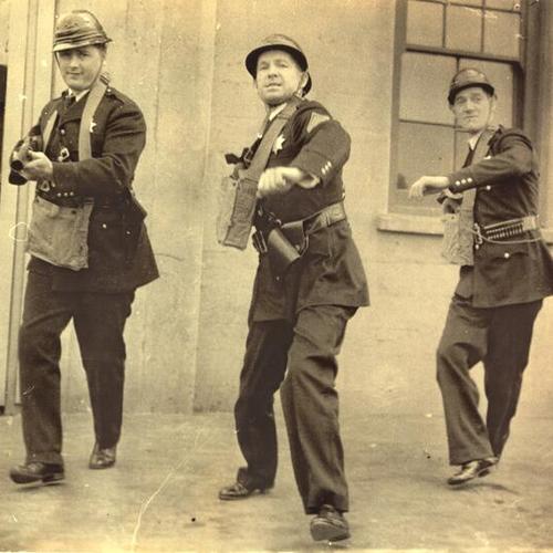 [Police officers in positions to drive back rioters during strike of 1934]