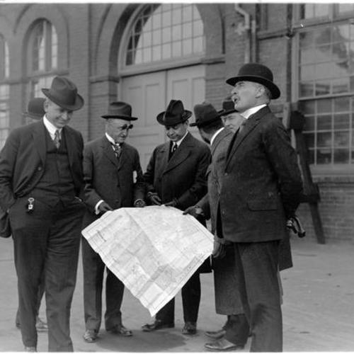 City engineer M. M. O'Shaughnessy (Right) and others outside building