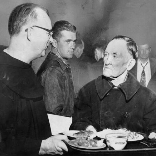 [Father Alfred Boeddeker serves the one millionth meal at St. Anthony's dining room]