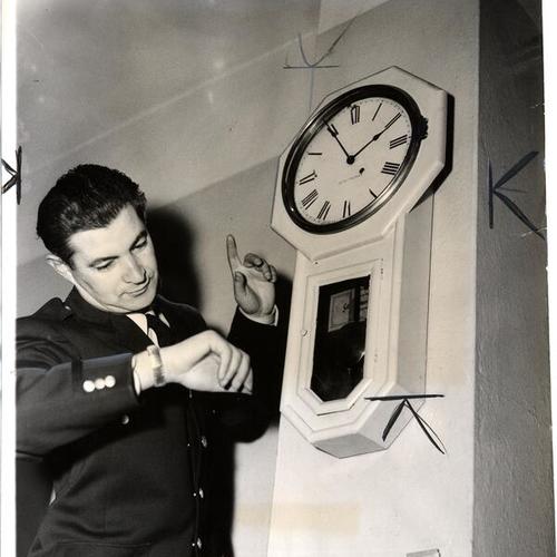 [Officer Manuel Mitchell checks the clock in the City Prison which was stopped by an early morning temblor]