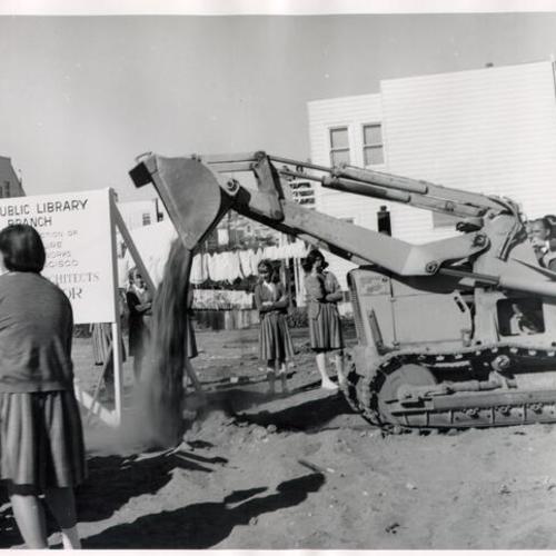 [Mayor Shelley operating machinery on the future site of the Excelsior Library]