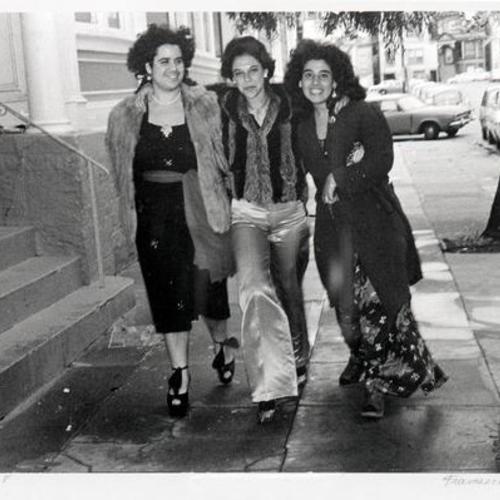 [Dressed up women walking down a Castro District street]