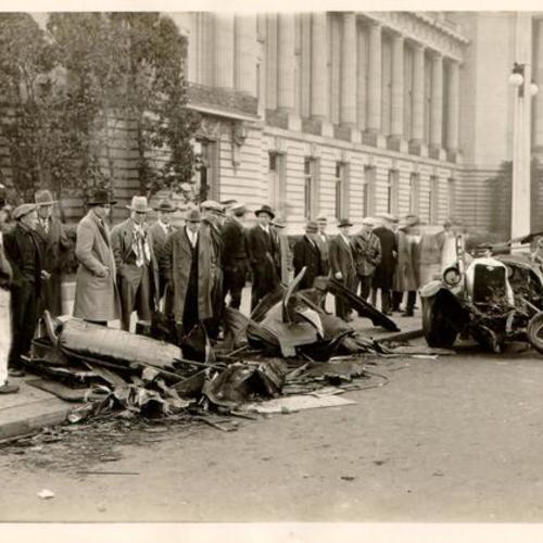 [Remains of an automobile that collided with a streetcar at Van Ness Avenue and McAllister Street]