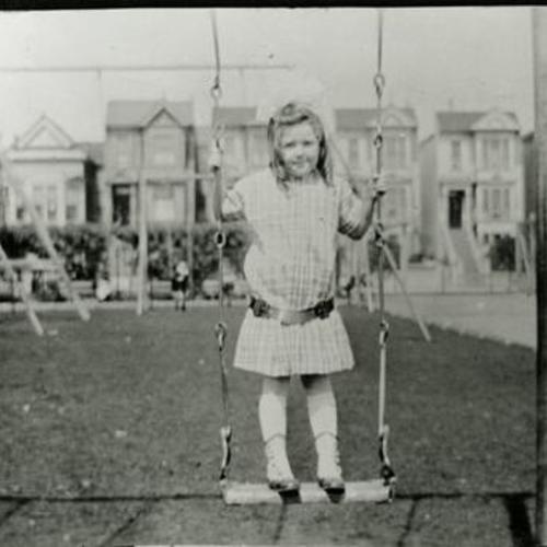 [Lorraine playing on swings in Hamilton Square Park in 1917]