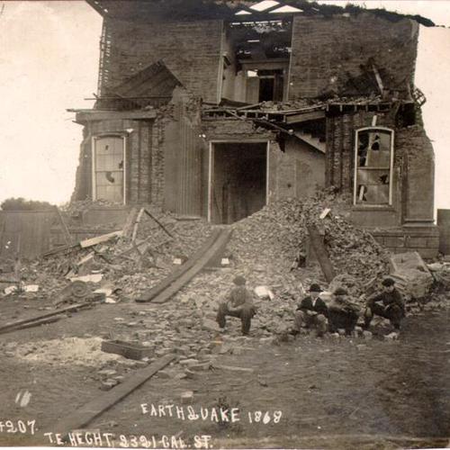 [Four people sitting near the ruins of a building after the 1868 earthquake]