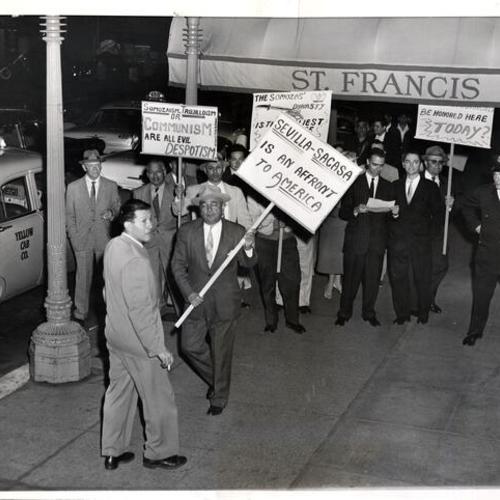 [Group of Central American people picketing a banquet for 19 representatives of the Organization of American States at the St. Francis Hotel]