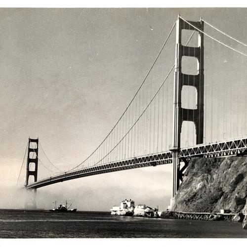 [View of a ship passing underneath the Golden Gate Bridge taken from the Fort Baker docks]