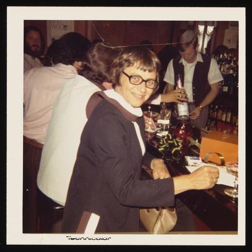 Portrait of person at bar with glasses